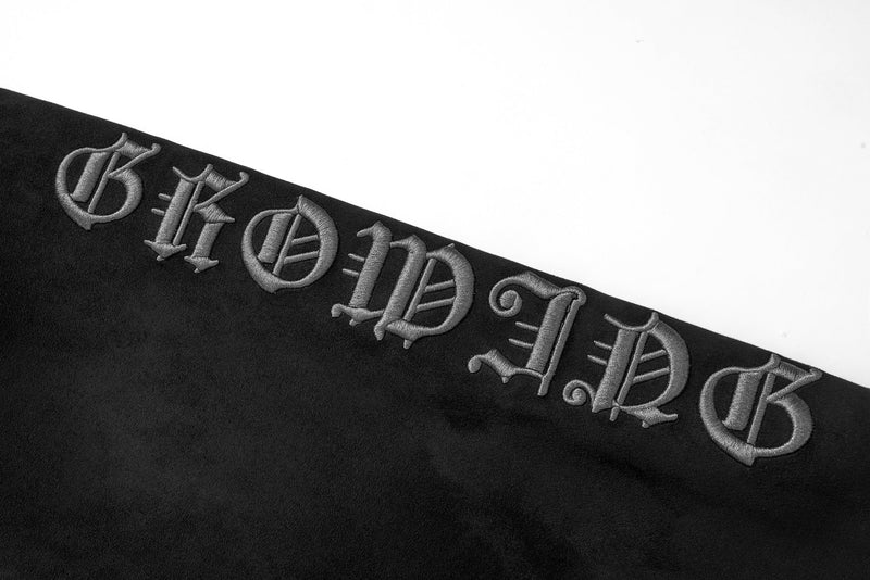 Close-up of sleeve embroidery spelling gothic letters on black suede hoodie