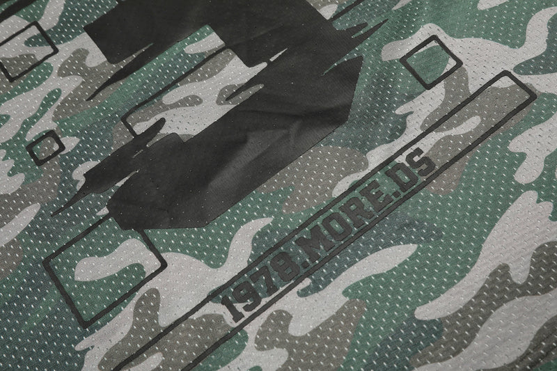 Green camouflage mesh jersey fabric with oversized black graphic print and bold streetwear lettering