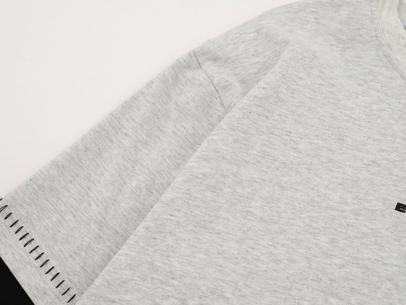 Close-up of heather gray sleeve and shoulder seam with contrast stitching