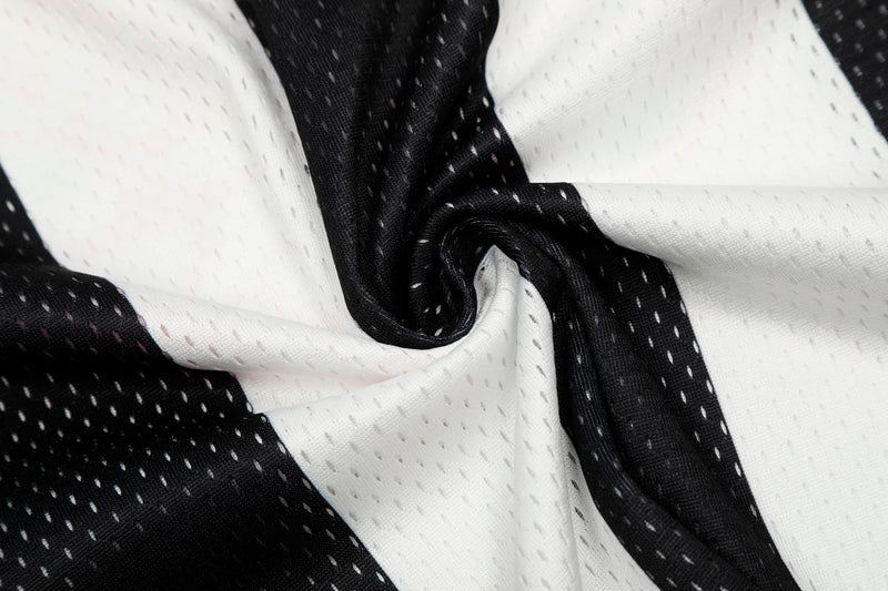 Close-up of gathered striped jersey fabric showing black and white mesh texture