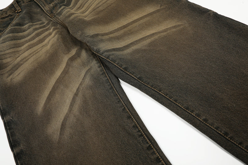 Leg detail of wide-leg jeans showing faded horizontal wash and straight denim panels