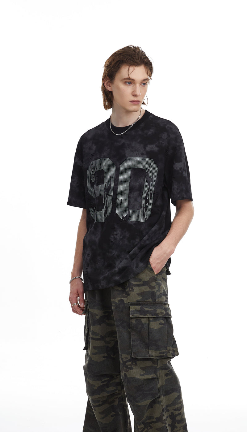 Black marble-wash oversized tee with large number graphic, styled with camo cargo pants on a male model
