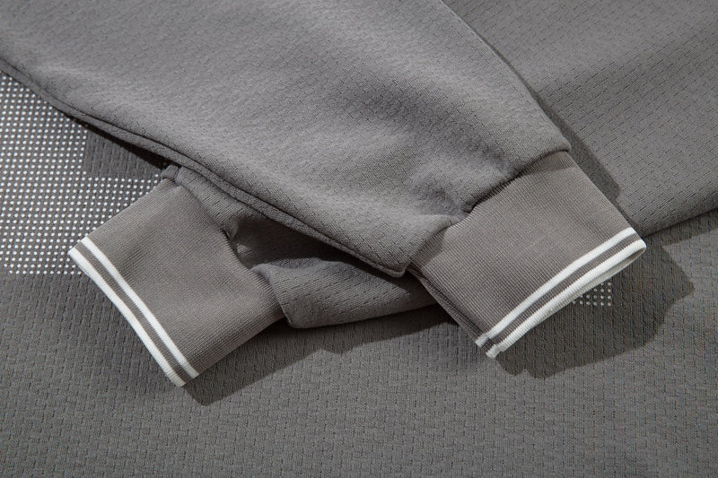 Gray long sleeve cuffs with white striped trim on the varsity mesh polo