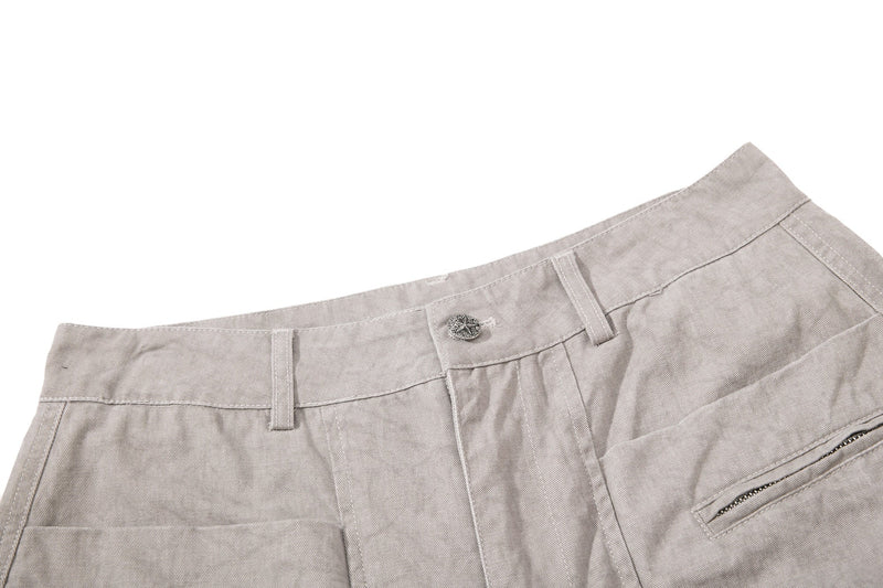 Light beige denim waistband close-up showing button, belt loops, and front pocket
