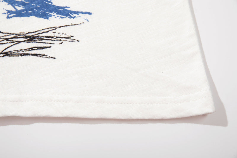 White graphic T-shirt hem with abstract blue and black sketch print on soft cotton fabric