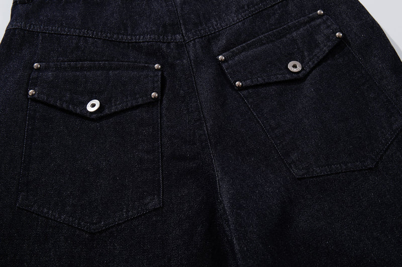 Close-up of back flap pockets with snap buttons on dark indigo denim pants