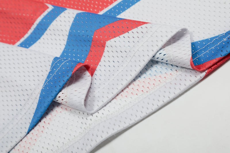 Close-up of a retro colorblock football jersey in white, blue, and red mesh fabric with stitched panels