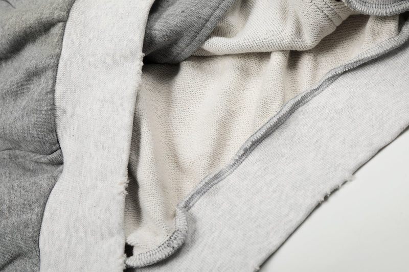 Close-up of hoodie interior with white fleece lining and gray outer fabric