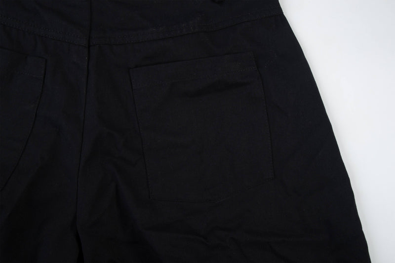 Close-up of black cargo pants back pocket and seam detail
