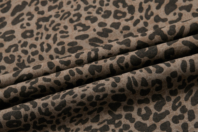 Close-up of brown leopard print ribbed fabric with soft folds, featuring a vintage Y2K streetwear polo tee pattern