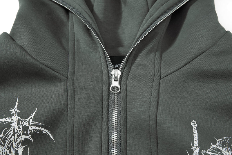 Close-up of front zipper and chest graphics on dark green hoodie