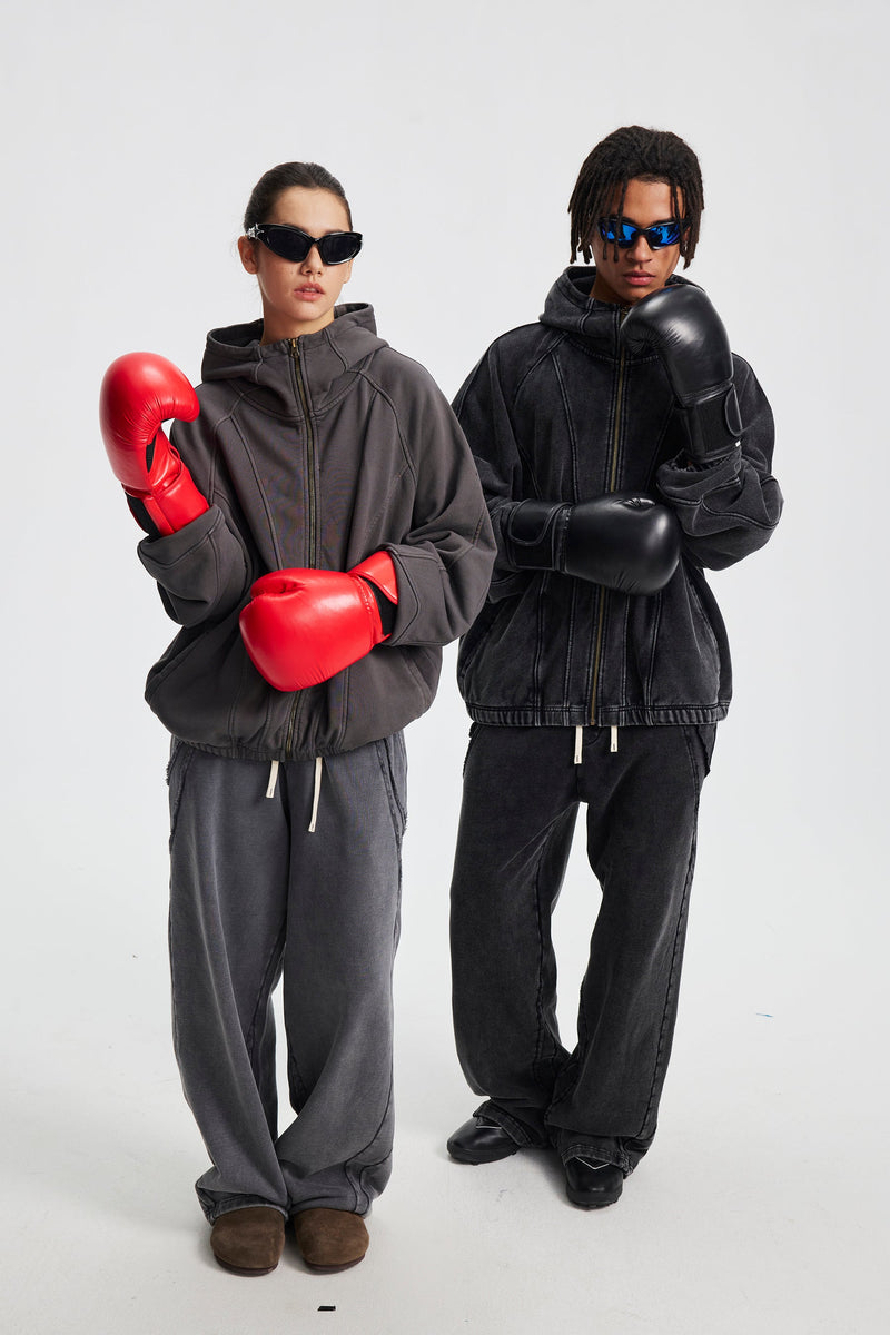 Two models wearing gray and black hoodies with boxing gloves, front view