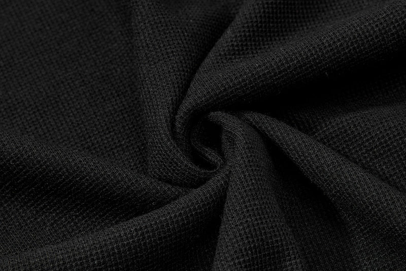 Close-up of black textured polo shirt fabric with soft folds and a dark gothic streetwear look