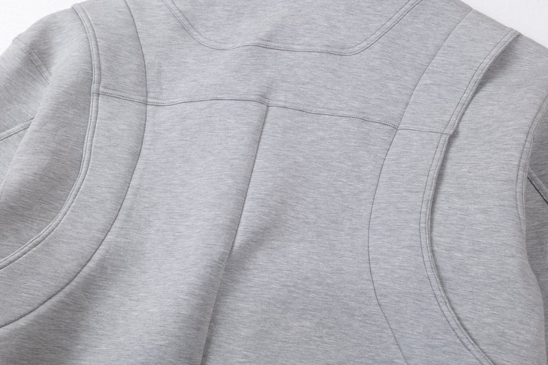 Close-up of back upper panel seams on light gray hoodie