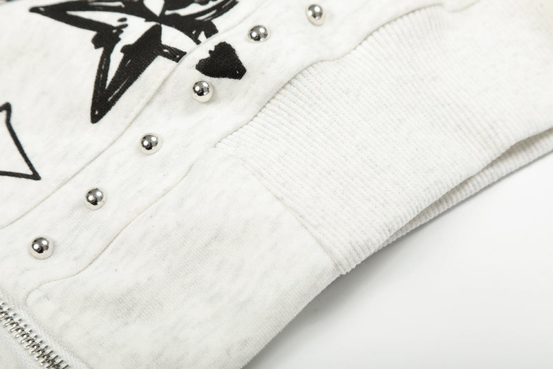Close-up of white hoodie side hem with ribbed cuff and silver studs