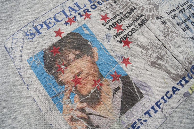 Close-up of graphic print on heather grey hoodie showing portrait and red stars