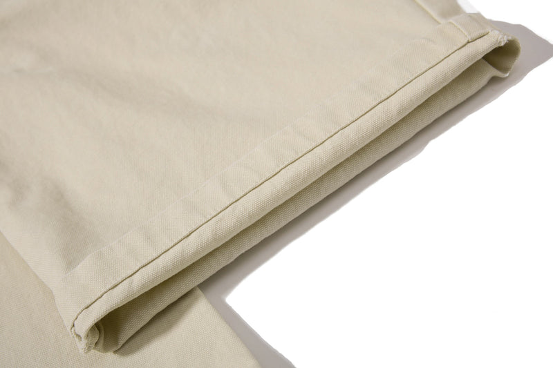 Close-up of beige cargo pant leg cuff stitching