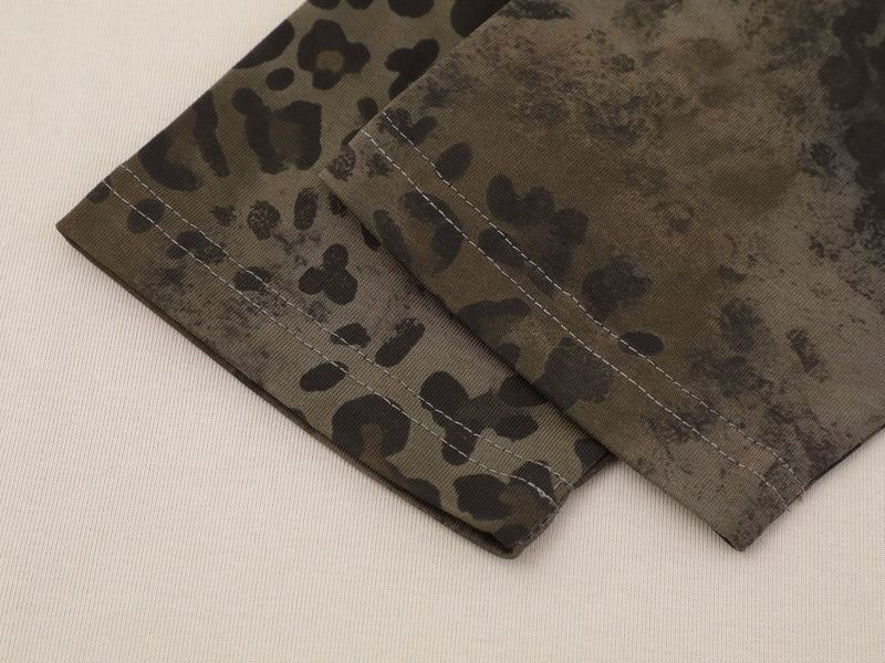 Leopard print sleeve cuff with gray stitching detail