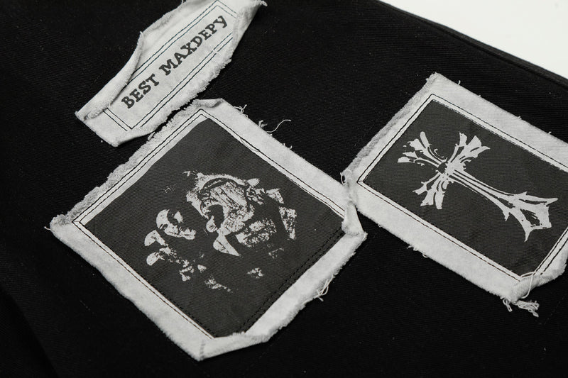 Close-up of BEST MAXDEPY patch and two graphic appliqué patches on black pants