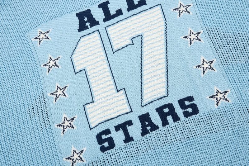 Light blue knit polo with varsity-style 11 graphic and star details, featuring a collegiate streetwear design
