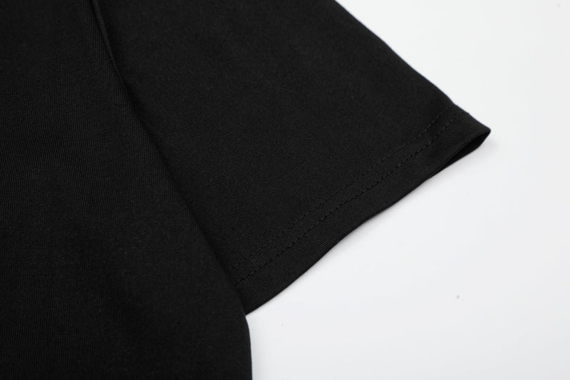 Close-up of a black T-shirt sleeve with neat double stitching on a white background
