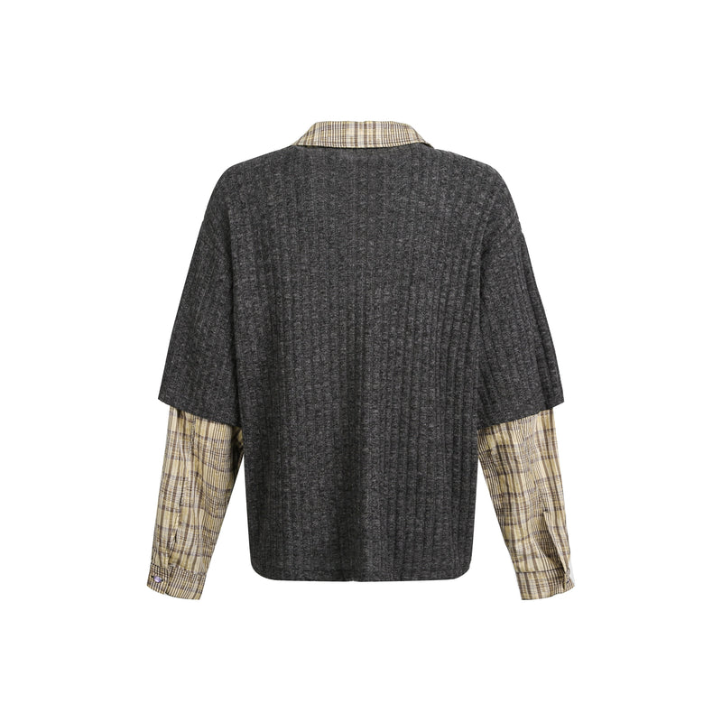 Back view of black ribbed knit sweater with plaid sleeve cuffs and collar