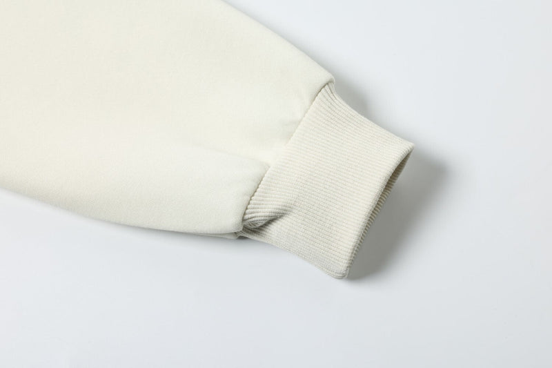 Cream hoodie cuff close-up with ribbed knit wrist detail