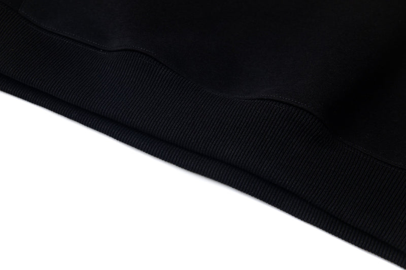Close-up of black hoodie hem with ribbed knit waistband texture