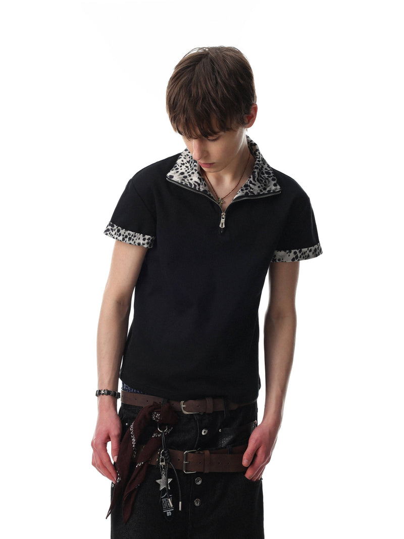 Black quarter-zip polo shirt with leopard print trim on collar and sleeves, styled on a model against a white background