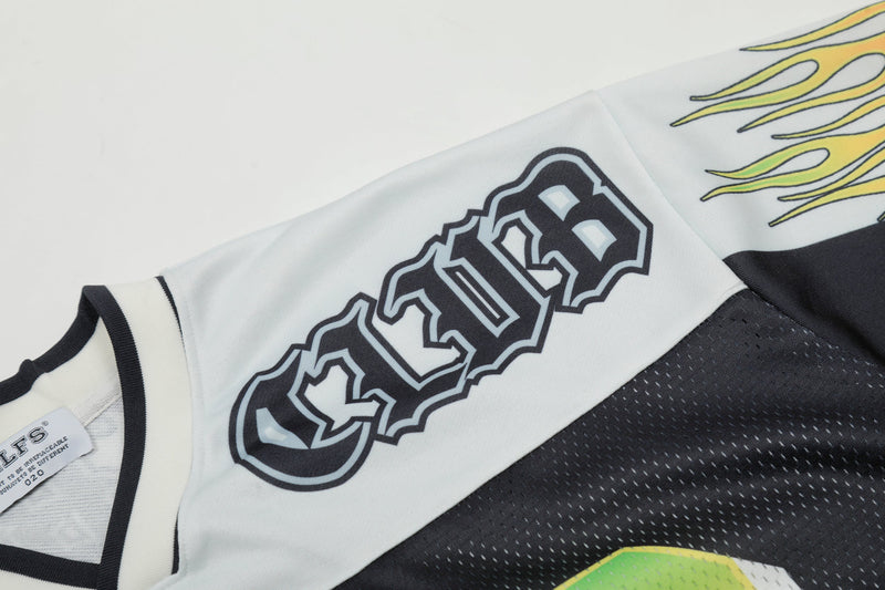Close-up of a white and black football jersey with bold number 23 and yellow flame graphics on the sleeve