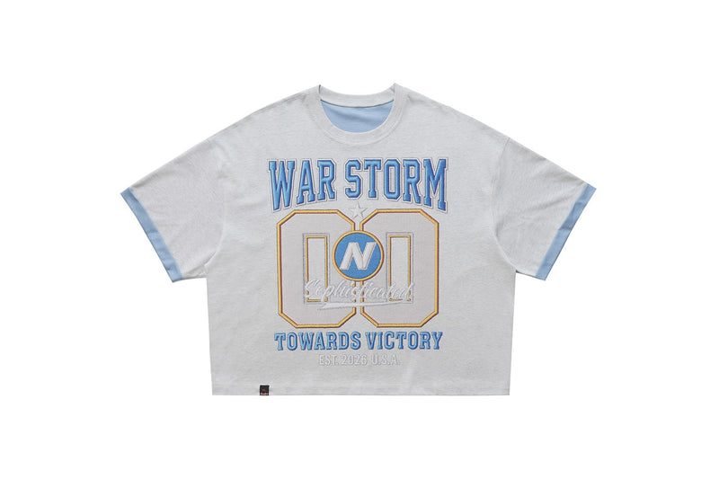Light gray varsity graphic tee with blue trim and bold WAR STORM 00 print on the front