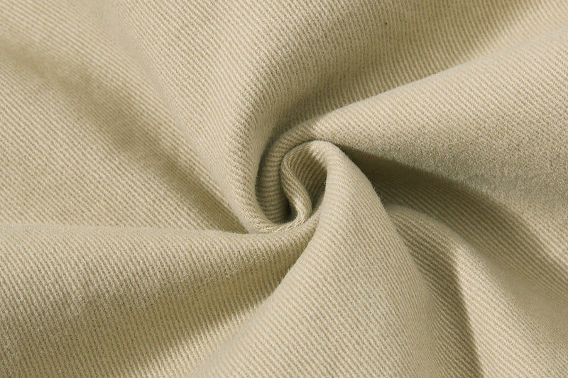 Close-up of beige twill fabric texture with folded drape