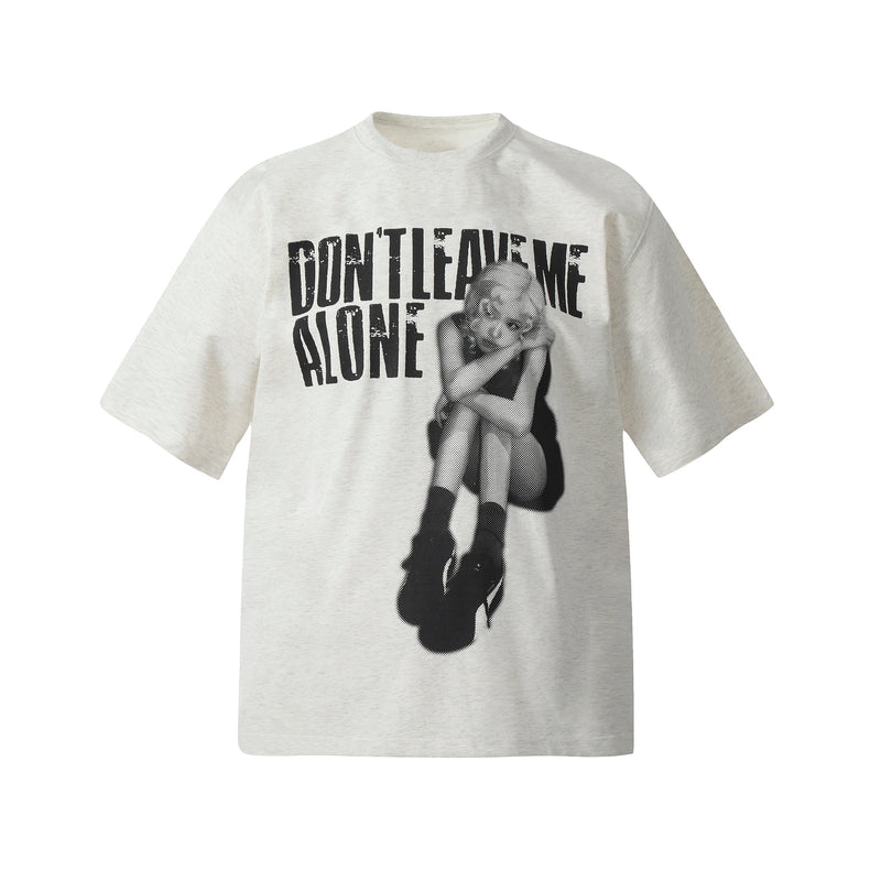 Cream oversized graphic tee with bold Dont Leave Me Alone print and distressed black graphic figure
