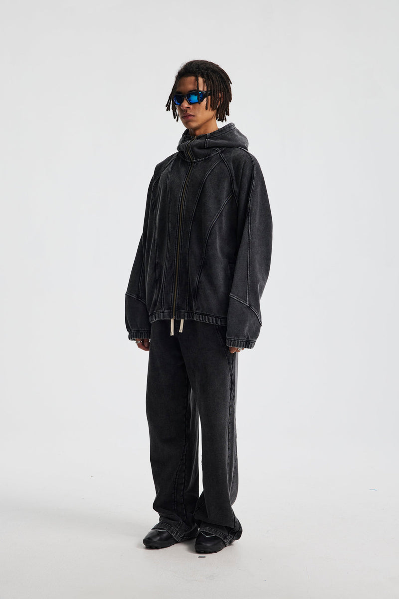 Three-quarter side view of black washed cotton hoodie on a model with hood down