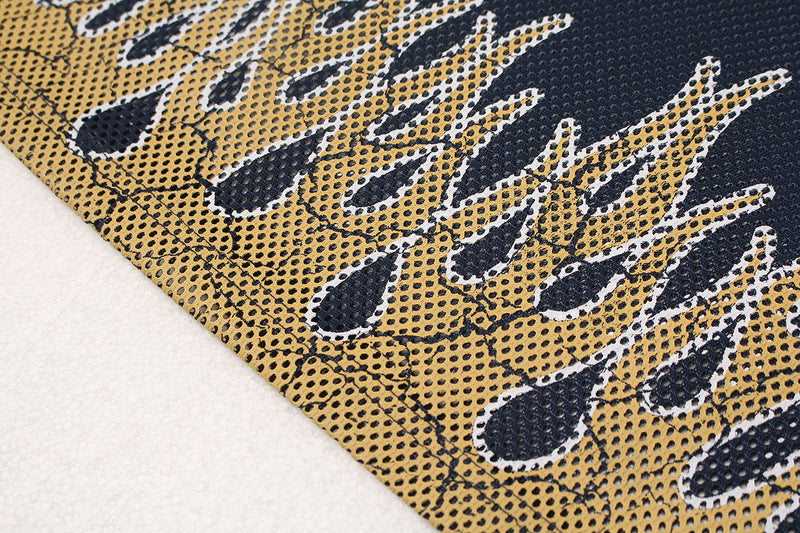 Close-up of navy mesh jersey fabric with gold flame graphics and white outlined details on a streetwear football top