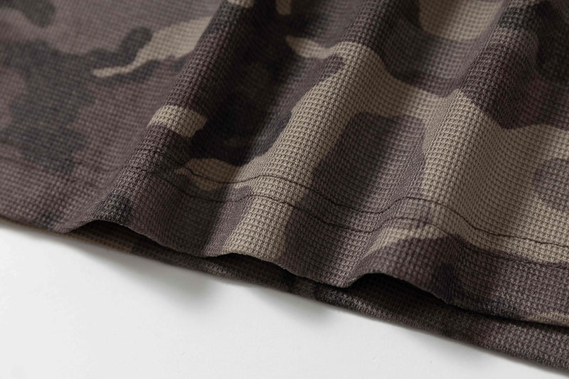 Close-up of camo hooded short-sleeve tee with textured knit fabric and brown-gray camouflage pattern
