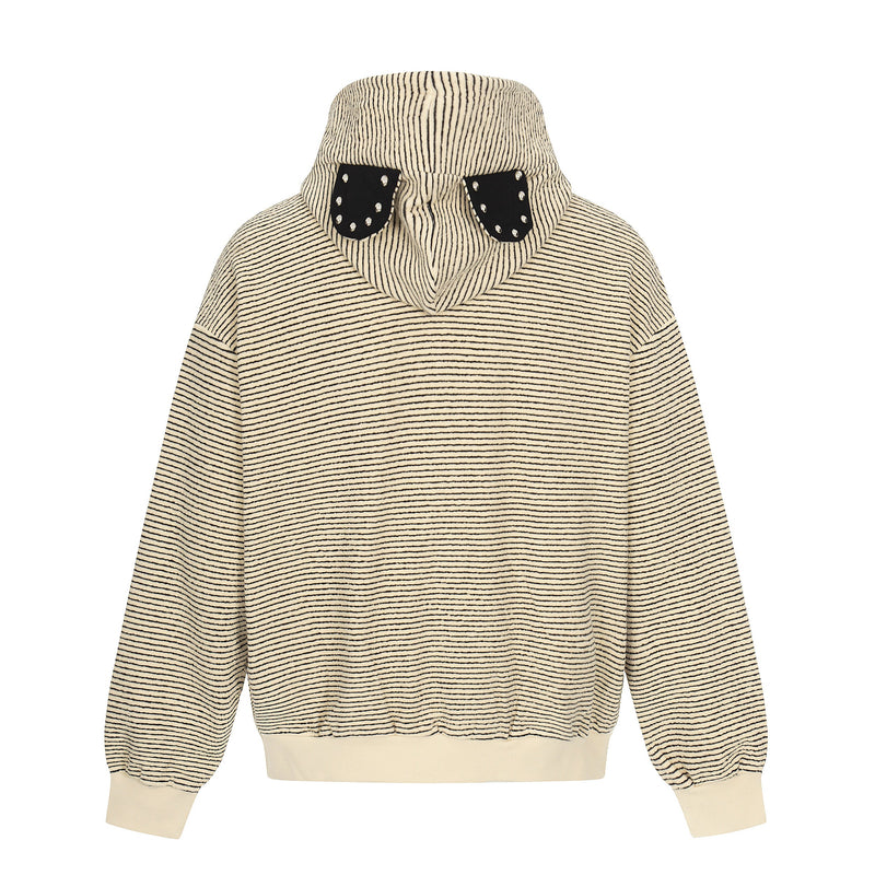 Back view of cream striped hoodie with black studded bear ears on the hood