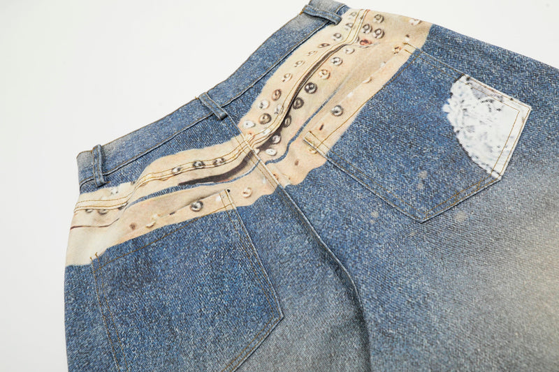 Back waist close-up of blue jeans with studded print and patch pocket detail
