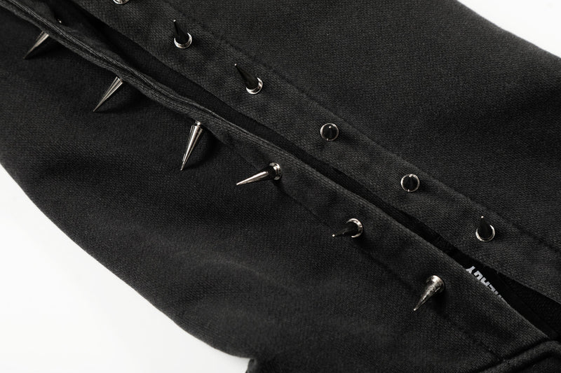 Close-up of black hoodie front pocket edge with silver spike studs