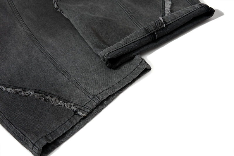 Close-up of hem cuff on black denim jeans with frayed edge detail