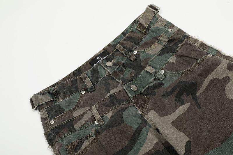 Close-up of the waistband and front pockets on camo cargo jeans with belt loops