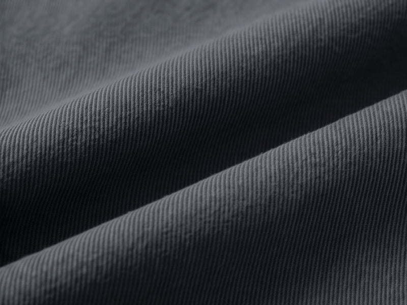 Close-up of black cotton fabric with diagonal ribbed texture