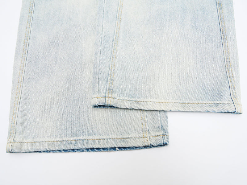 Folded hem detail on light wash wide-leg denim jeans