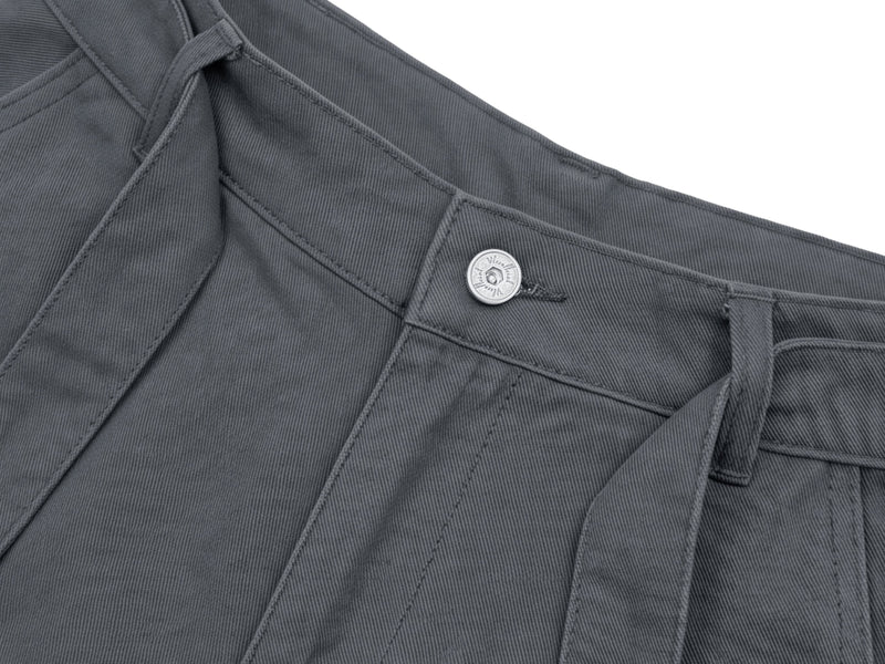 Close-up of charcoal shorts waistband with pleats and button detail