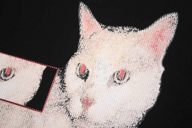Black streetwear T-shirt with a glitch-style white cat graphic and pink eyes on the front