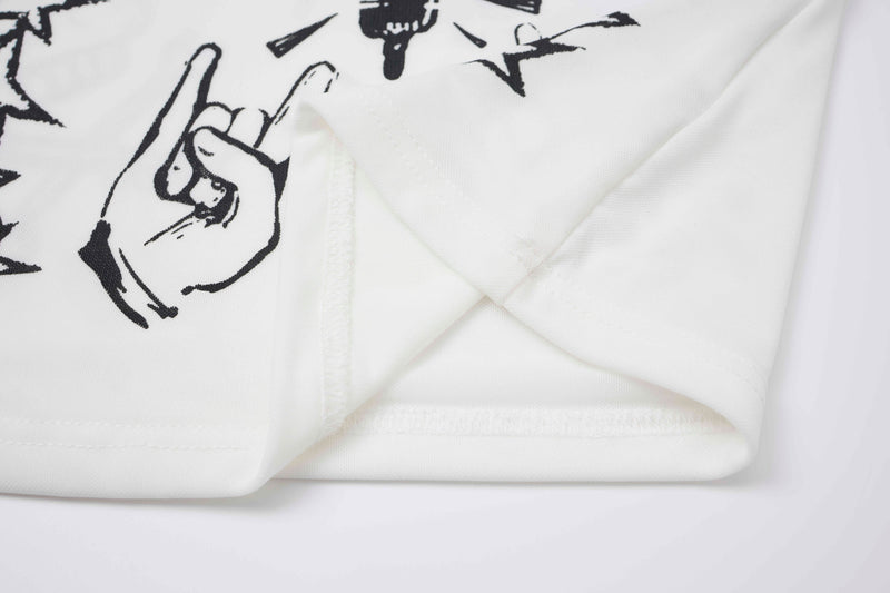 Close-up of white top hem seam with black graphic print
