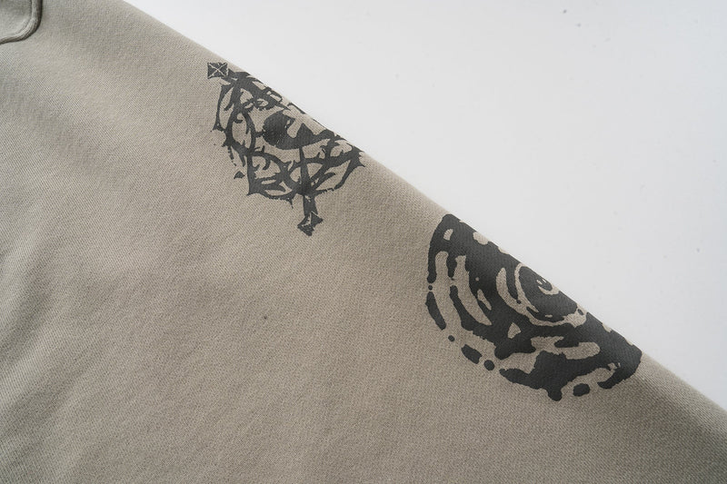 Black graphic print along the taupe hoodie sleeve
