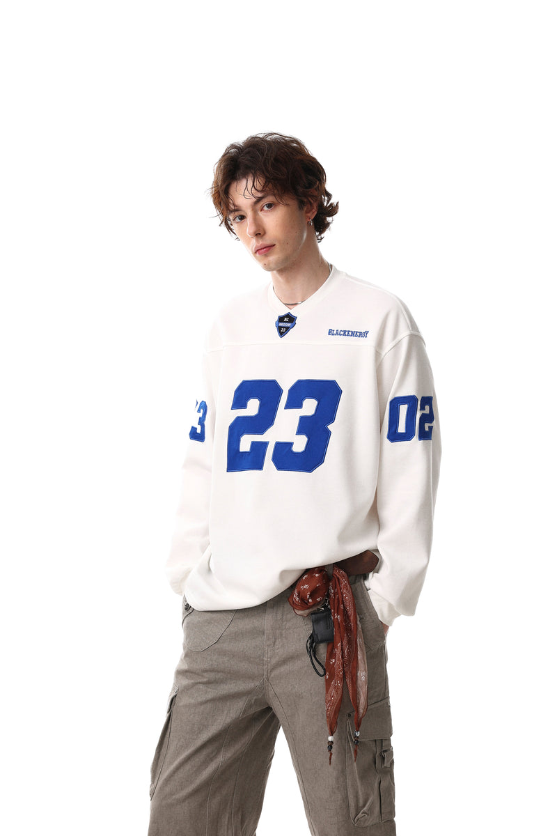 White long sleeve tee worn with blue number 23 graphic and sleeve numbers, full-body view