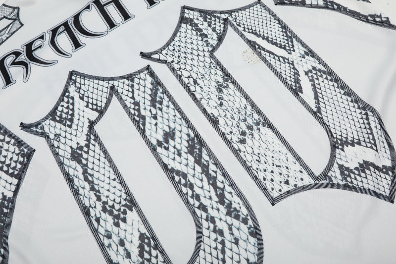 Close-up of a white gothic jersey tee with black snakeskin print and bold Seakoff lettering, streetwear style