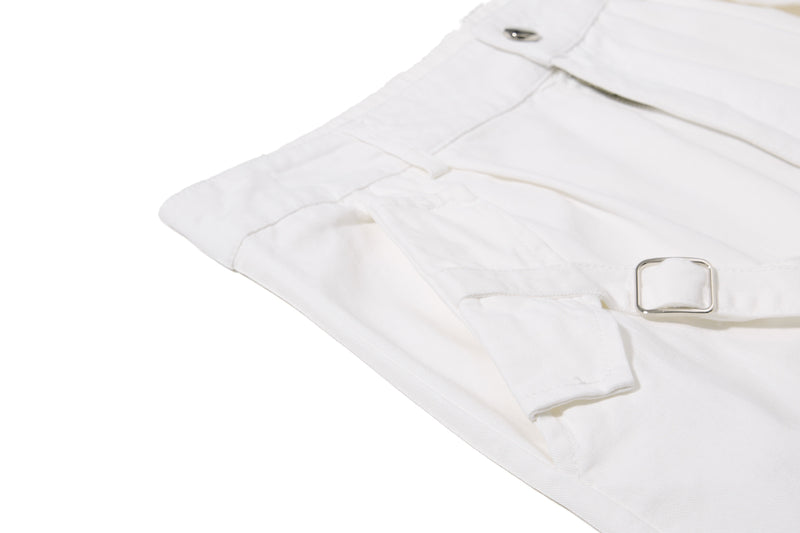 White shorts side strap and metal buckle detail, close-up